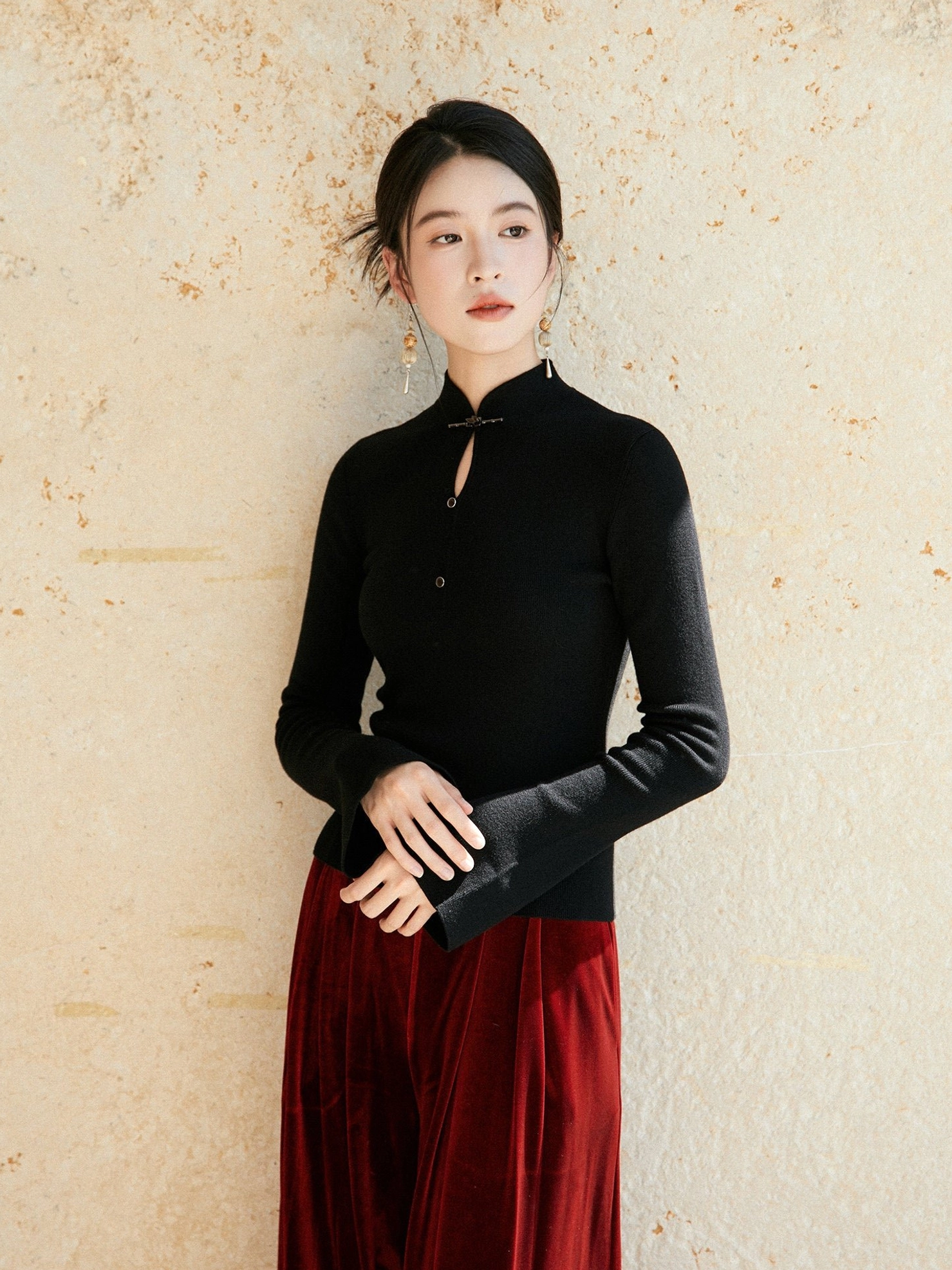 Black modern Hanfu wool knit sweater with Chinese frog button stand collar paired with burgundy velvet midi skirt front view