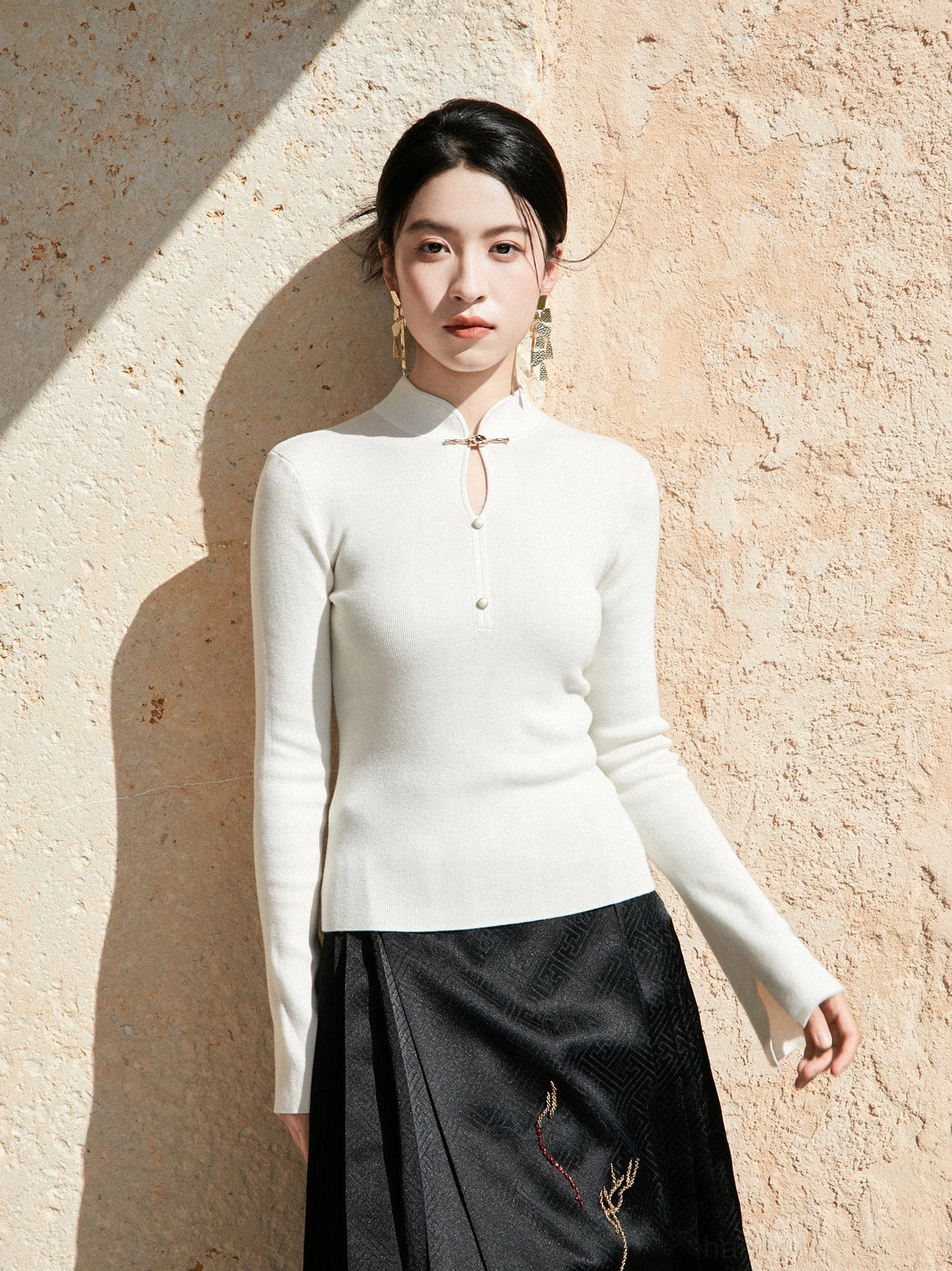 White modern Hanfu 100 percent wool ribbed knit sweater with Chinese stand collar frog buttons and black embroidered mamian skirt front view
