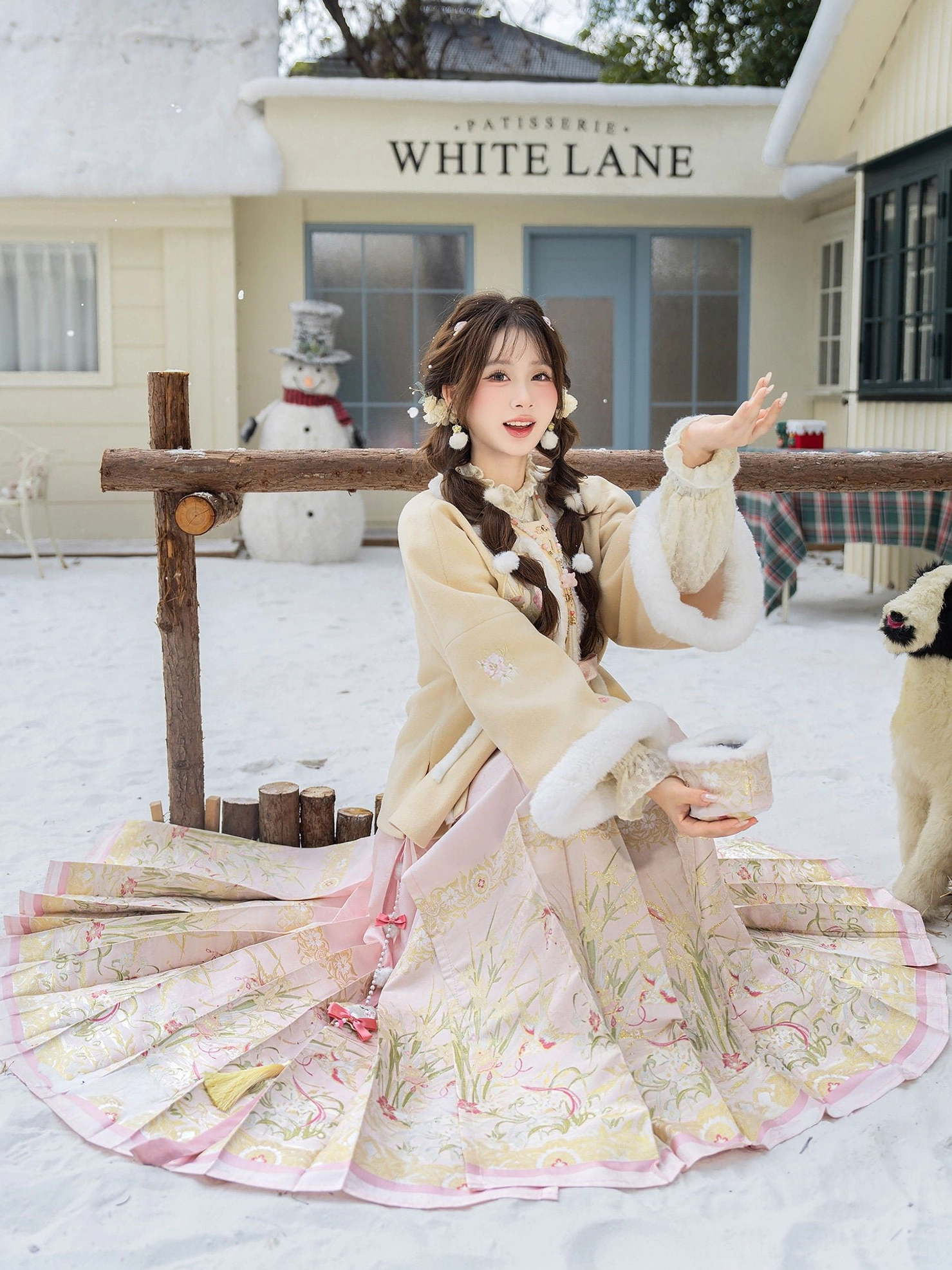 Side sitting view of a warm winter Hanfu Mamian skirt suit with wide pleats, floral embroidery, and matching beige fleece jacket