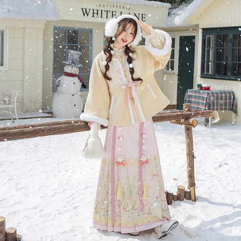 Front side view of a winter Ming Dynasty Hanfu suit with beige fluffy jacket, pink embroidered Mamian skirt, and white plush handbag