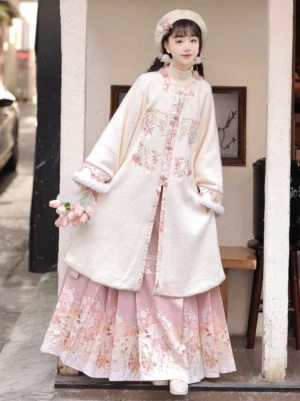Pink Winter Warm Sun Ming Dynasty Hanfu set with cream embroidered square collar velvet cardigan and pink floral printed mamian skirt front three-quarter view
