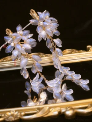 Wisteria Chinese hair pin set with translucent pale blue lavender glass blossoms and delicate hanging tassels displayed on a vintage golden tray