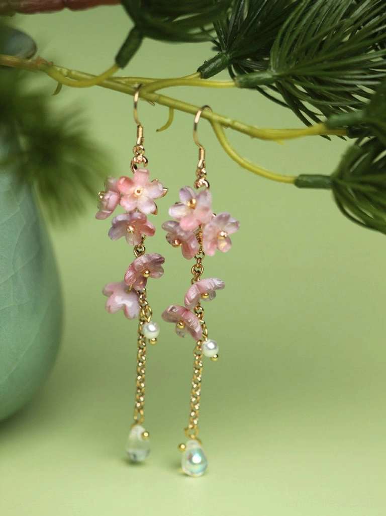 Front view of symmetrical pink wisteria flower hook earrings with gold chains, pearl beads and iridescent drop pendants for Hanfu styling