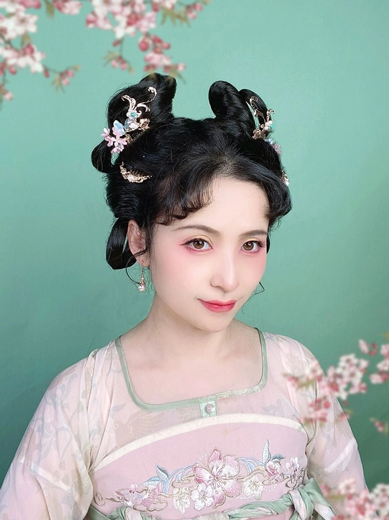 Asian woman wearing a pink hanfu dress and traditional coiled hairstyle decorated with elegant vintage Chinese floral hair pins against a cyan and pink floral backdrop