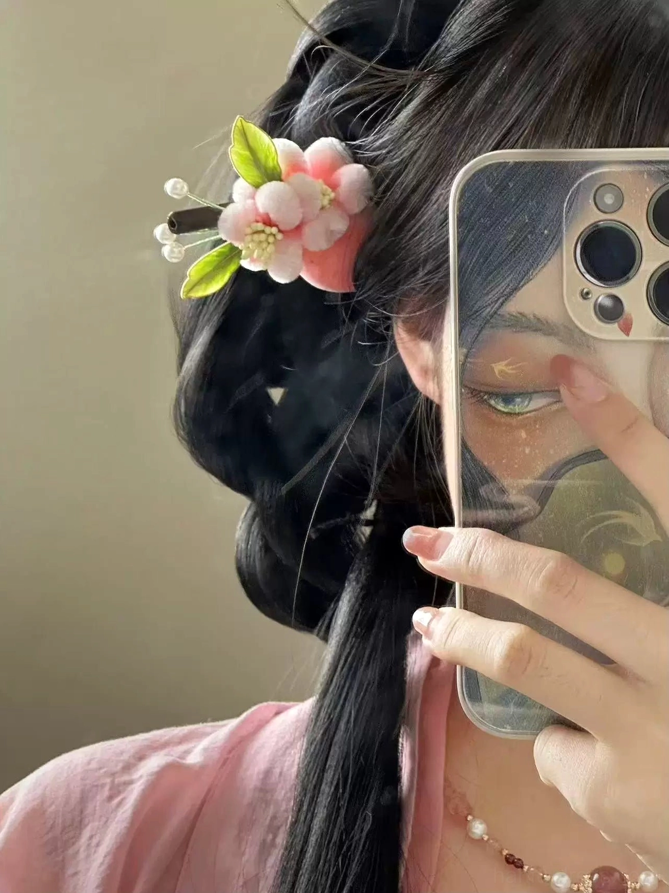 Woman wearing a pink plush flower Chinese hair stick with Hanfu hairstyle and pearl necklace