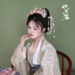 Woman wearing a complete Yunhuali hanfu hair accessory crown with side tassel ornaments and a glittering beige traditional Chinese outfit