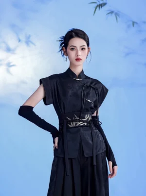 Three-quarter front view of women black Chinese wuxia costume with stand collar frog buttons long bracers and embroidered bamboo waist belt