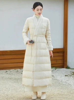 Women’s off-white Hanfu-inspired long winter down coat with cross-over collar, plush trim, floral embroidery, and drawstring waist front view