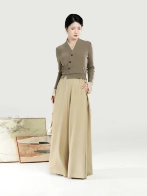 Women’s modern Chinese style Hanfu outfit featuring a fitted V-neck knit top and flowing high-waisted beige palazzo pants in a three-quarter front view