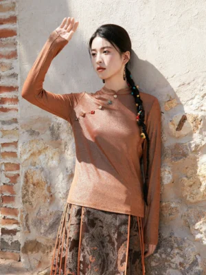 Caramel brown Chinese-inspired satin shimmer modern Hanfu top with stand collar, slanted decorative buttons, long sleeves, and vintage midi skirt styling