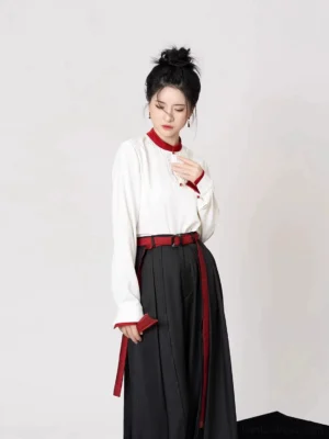 Women’s modern Hanfu outfit featuring white stand-collar top red-trimmed embroidered vest and high-waisted black wide-leg pants