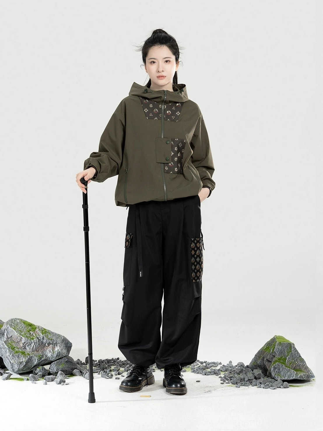 Women’s olive green Modern Hanfu outdoor outfit with half-zip hooded jacket relaxed straight-leg cargo pants and walking stick