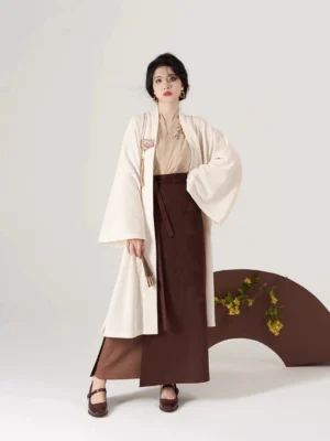 Front view of Wood Hibiscus Song Dynasty Hanfu outfit with beige cross-collar top, flowing cream cardigan, and dark brown high-waisted wrap skirt