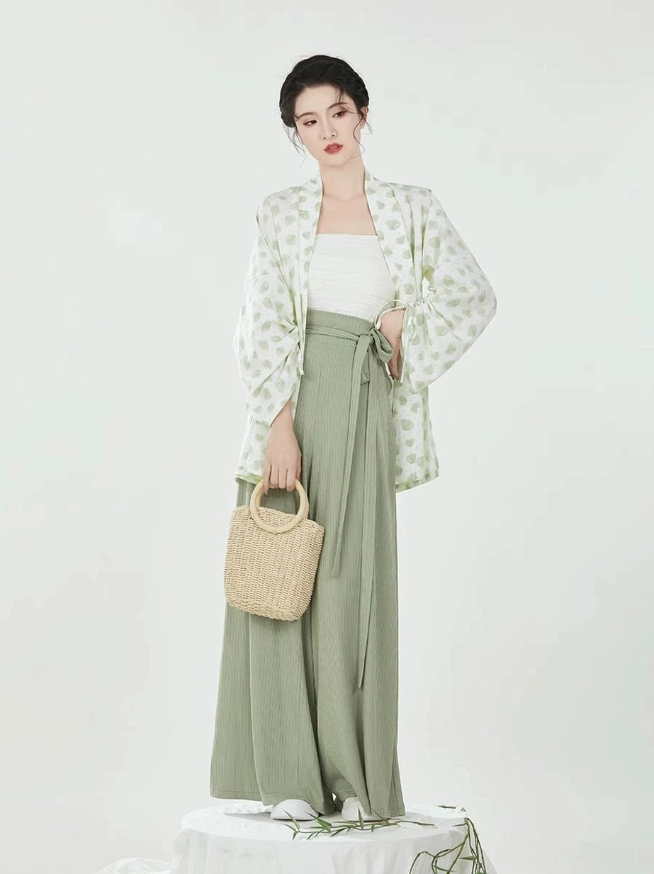 Front view of Wrapped Leaves Song Dynasty modern Hanfu set with ivory leaf-print winged sleeve top and sage green wide-leg pants