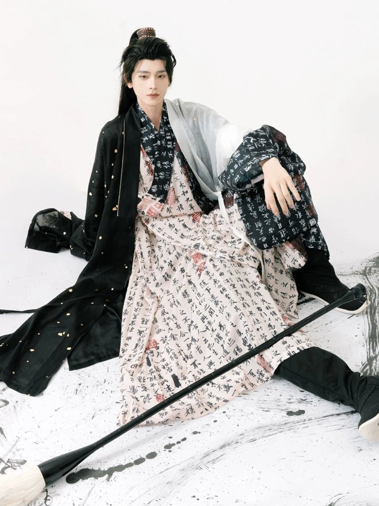 Relaxed wuxia inspired men's Taoist style hanfu with black outer coat, calligraphy robe, and subtle gold fleck details