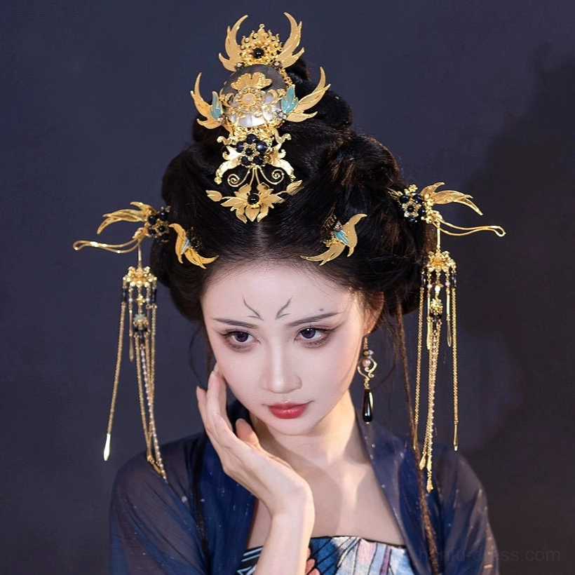Three-quarter portrait of Xi Wei Chinese Hanfu hair accessory set with gold crown, blue accents, side ornaments and long tassel hair jewelry