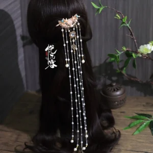 Xiao Yao traditional Chinese back hairpin worn in dark brown hair with rose gold filigree, pink gemstone, blue beads, faux pearls, and long layered tassels