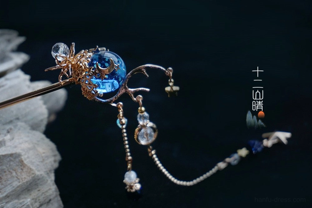 Detailed side close-up of Xingyue starry sky Chinese hair stick with crystal embellishments, gold tone framework, layered bead tassels, and star charm