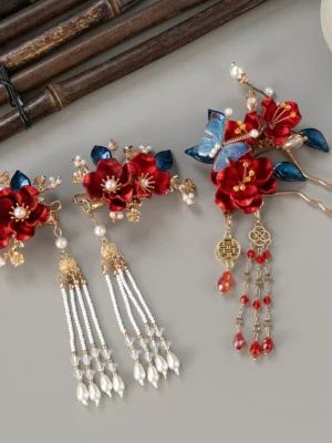 Complete Xiuhe bridal hairpin and hair clip set with red fabric flowers blue butterfly leaves gold-tone details and pearl tassels on a gray flat lay background