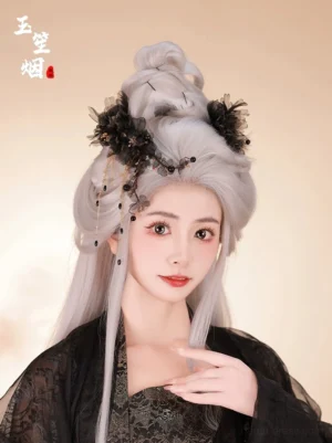 Model wearing a black floral Hanfu hairpin with gold chain tassels and dark bead drops in a silver-gray ancient-style updo