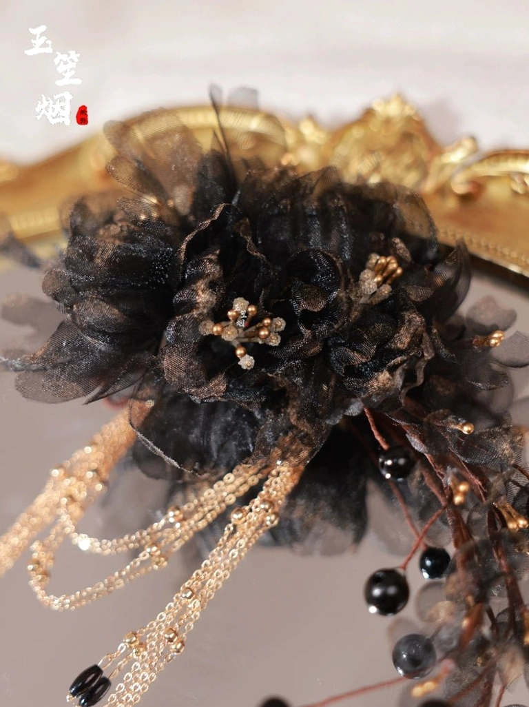Detailed top-down view of the black sheer floral Chinese hairpin with gold decorative centers chain tassels and branch-inspired accents