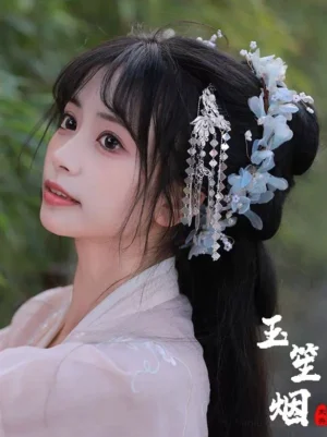 Side view of light blue flower Hanfu hair ornaments with long silver tassels styled with a pink traditional Chinese outfit