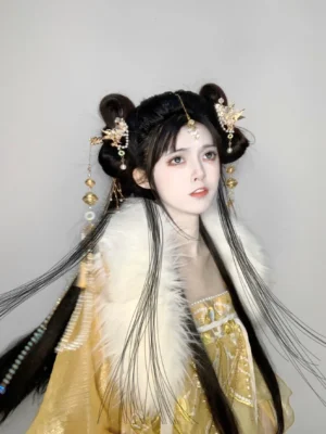 Model wearing a complete traditional Chinese Hanfu hairstyle with gold hair ornaments, pearl details, yellow tassel hairpins, and a golden Hanfu outfit