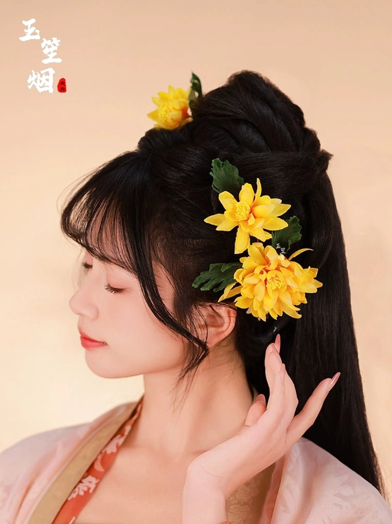 Yellow chrysanthemum Chinese hair pin set decorating an elegant high bun for a Hanfu-inspired hairstyle