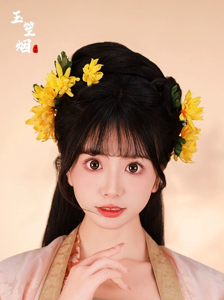 Yellow chrysanthemum Hanfu hair pin set worn by a woman with a traditional Chinese hairstyle in a warm studio portrait