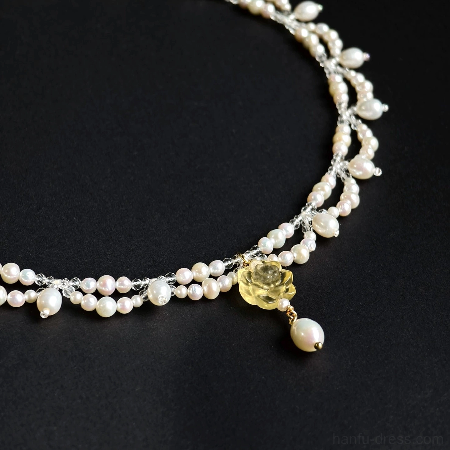 Yellow rose pearl yingluo Chinese necklace flat lay showing long pearl chain and teardrop freshwater pearl pendant