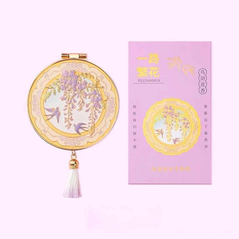 Yi Lu Fan Hua Chinese folding pocket mirror with wisteria and swallow artwork, gold-tone frame, purple-white gradient tassel, and matching card