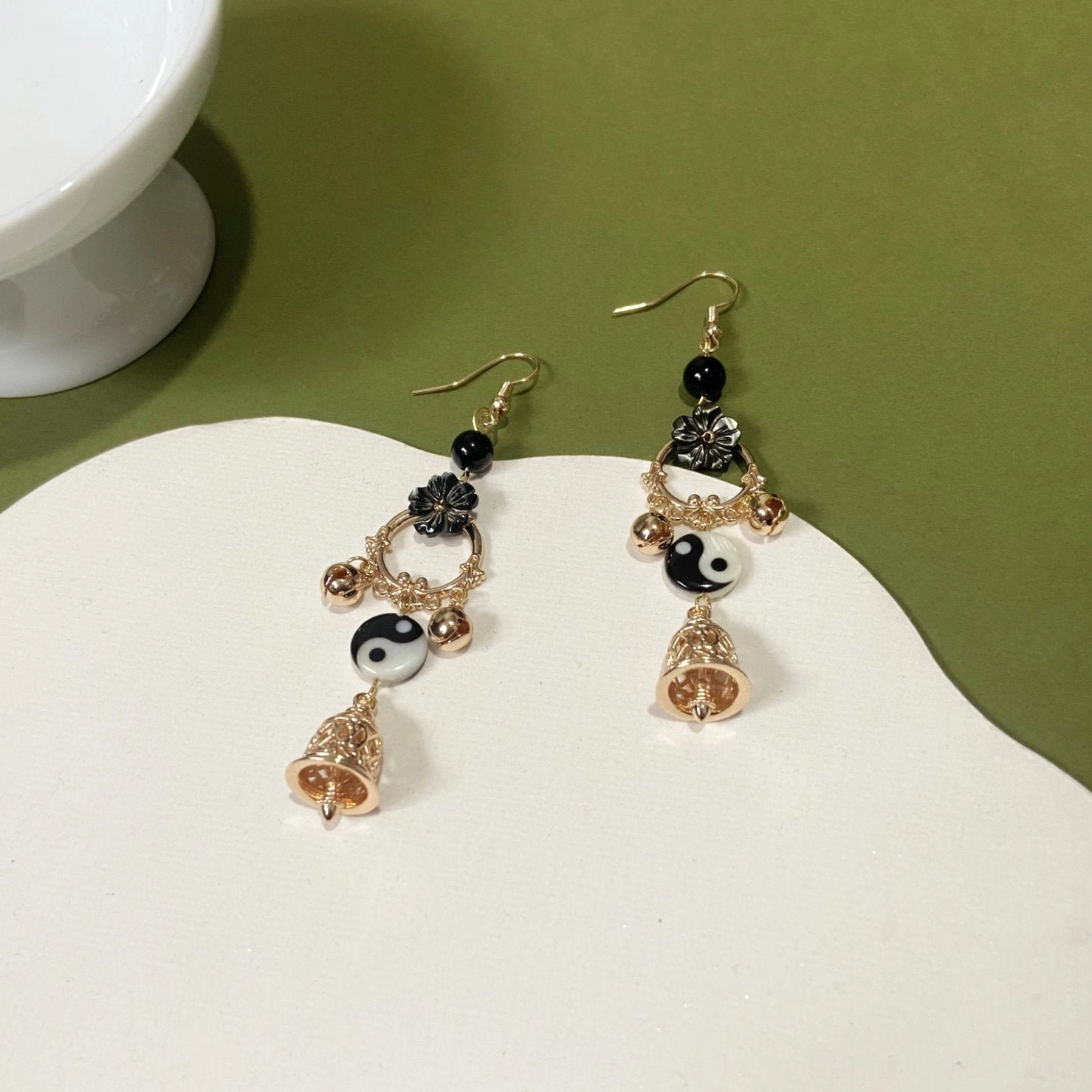 Yin Yang dangle Hanfu earrings with fishhook fittings black beads black floral ornaments gold tone Tai Chi charms and hollow carved bell pendants