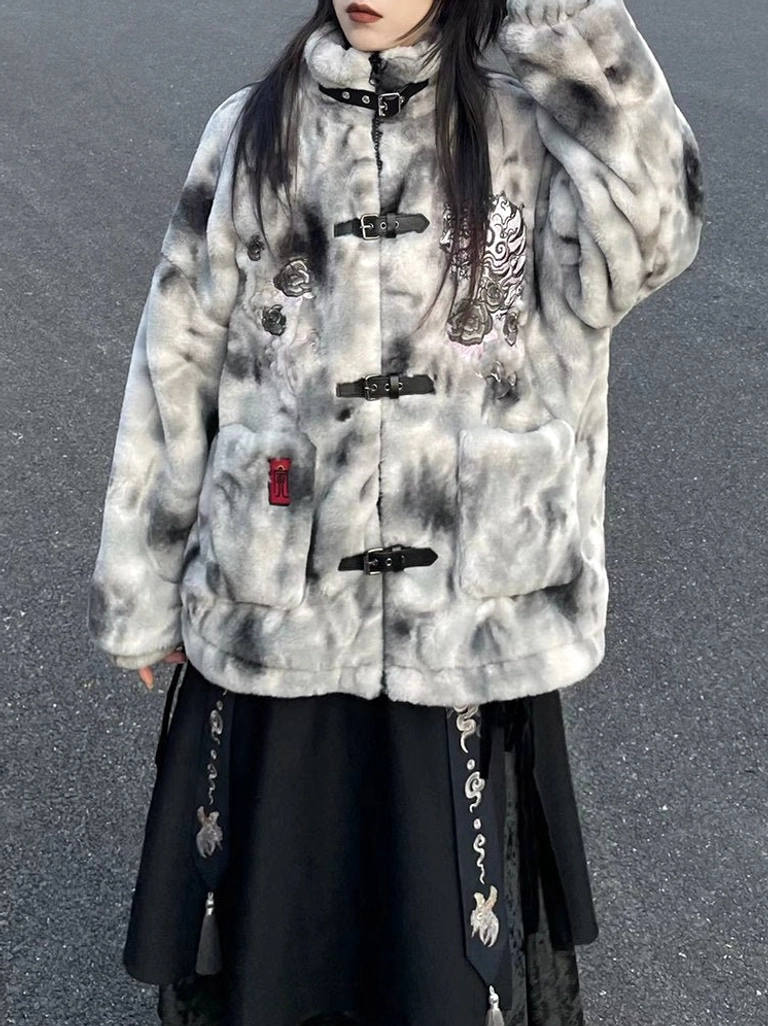 Close-up front view of Yinhu Tiger Chinese style faux fur jacket featuring detailed chest embroidery, leather-look buckle placket, front patch pockets, and a dark embroidered tassel skirt