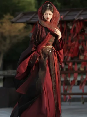 Front three quarter view of a Yuji Lament Wei Jin Hanfu dress with red inner robe, black sheer outer layer, silver decorative waist belt, hooded veil, and traditional hair jewelry