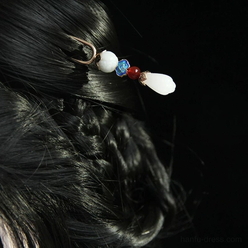 Yulan magnolia Chinese hair stick worn in a traditional braided updo, showing the double-pronged hairpin structure and elegant vintage Chinese decorative details