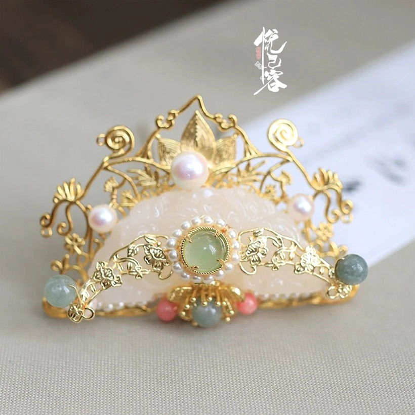 Three-quarter close-up of the Yun Yan Ji traditional Chinese Hanfu crown showing delicate gold filigree, pearl accents, green details, and clustered decorative beads