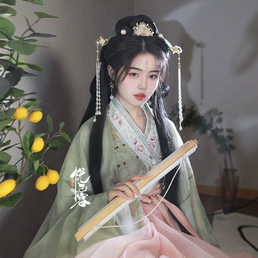 Model wearing Yun Yan Ji Chinese Hanfu hair accessories with a decorative crown, side hairpins, and long pearl tassels styled with a green and pink Song-style Hanfu outfit