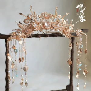 Large vintage gold Yunhuali hanfu hair crown with floral filigree, faux pearls, light blue jade-inspired beads, and long dangling tassels displayed on a wooden stand