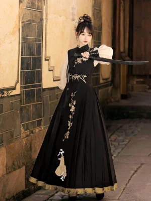 Front three-quarter view of Yunshan wuxia Hanfu dress with black embroidered vest, ivory lantern sleeves, pleated skirt and traditional sword