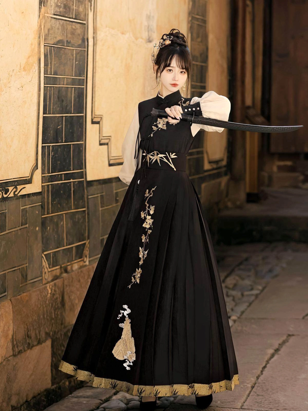 Front three-quarter view of Yunshan wuxia Hanfu dress with black embroidered vest, ivory lantern sleeves, pleated skirt and traditional sword