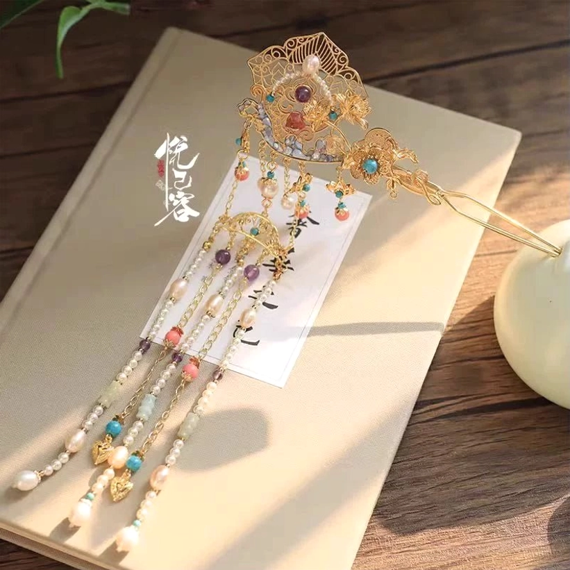 Yunyan gold tone filigree Hanfu hairpin with blue beads pearls and layered long tassel pendants on wooden table