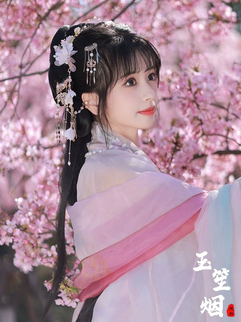 Rear side view of Yuyue Hanfu hair accessories styled on a pink Hanfu updo with floral pearl hairpins and long gold-tone tassels