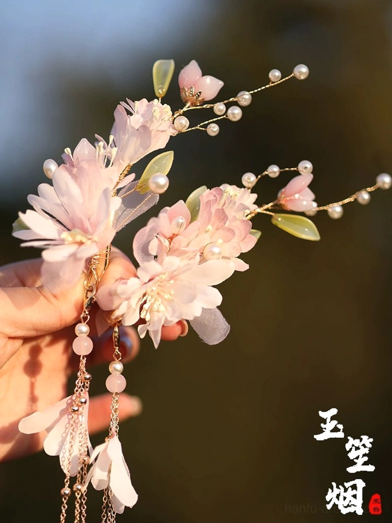 Detailed close-up of Yuyue pink floral Chinese hair ornament with layered fabric blossoms pearl decoration chain tassels and petal pendants