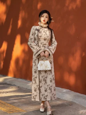 Long bamboo print winter cheongsam dress with fur-look collar and cuffs, stand collar, frog buttons, and slim floor-length silhouette