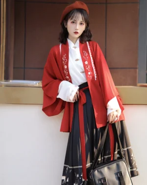 Front view of red Ming-inspired modern Hanfu three-piece outfit with pink floral embroidered cardigan, white stand-collar blouse, pleated deer-print midi skirt and red beret